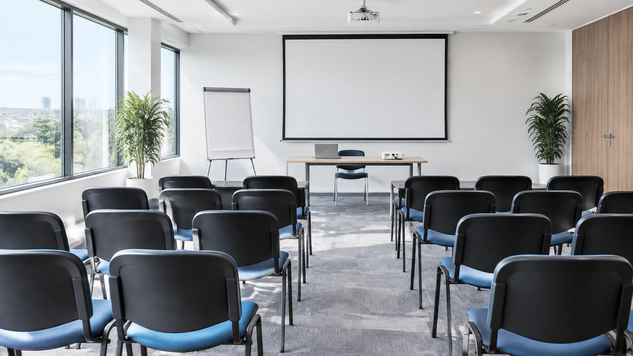 Conference room prepared for a workshop with chairs and a flipchart